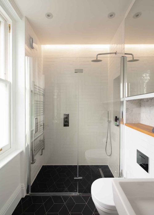 Overview of bathroom with shower and basin